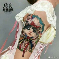 a woman with a cat tattoo on her arm and shoulder, showing it's image