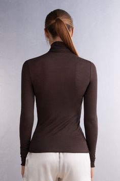 Long-sleeve top in soft modal cashmere ultralight with a high-neck design. Due to transparent nature of ultralight material, we recommend pairing with Ultralight Microfiber Top. Elegant Stretch Top With Funnel Neck, Elegant Stretch Funnel Neck Top, Fitted Brown Tops With Seamless Collar, Elegant Funnel Neck Stretch Top, Elegant High Stretch Mock Neck Top, Chic Turtleneck Top In Solid Color, Chic Solid Color Turtleneck Top, High Neck Solid Color Top For Layering, High Stretch Solid Color Turtleneck Top