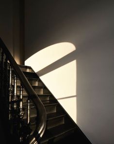 shadows cast on the wall next to a stair case