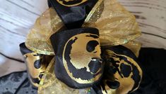 a black and gold hair bow with a lion on it