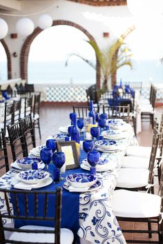 the tables are set with blue and white plates