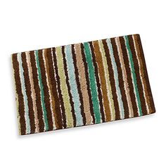 a bath mat with multicolored stripes on the front and back of it's surface