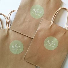 three brown paper bags with labels on them