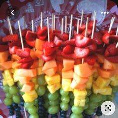 fruit skewers with strawberries, grapes, and melon on them are ready to be eaten