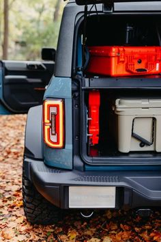 the back end of a pickup truck with coolers in it's cargo compartment