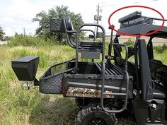 a black utility vehicle parked in the grass