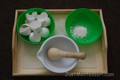 a wooden tray topped with bowls filled with white and green food next to a rolling pin