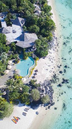 an aerial view of a tropical resort and pool