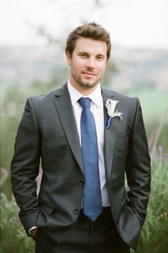 a man in a suit and blue tie