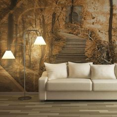 a white couch sitting in front of a wall mural