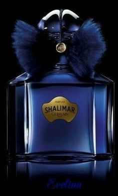 a bottle of shalimar perfume on a black background