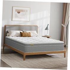 an image of a mattress on a bed frame in a room with white walls and carpet