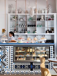 a woman standing behind a counter in a store