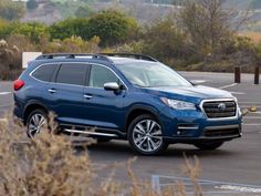 a blue subarunt parked in a parking lot