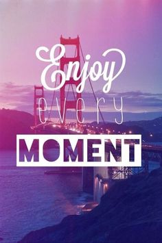 the words enjoy every moment in front of a bridge