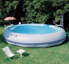 an inflatable swimming pool with lounge chairs around it