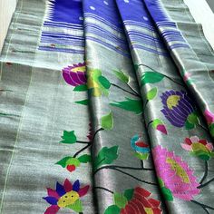 This exquisite regal paithani saree is handwoven in bluish purple color. Silver zari dollar buttis adorn the body while the silver zari border is decorated with handwoven in muniya border. The elaborate pallu is woven with colorful lotus along with winding vines. The saree comes with plain blouse with matching borders. Approximate Length 6.5 mtrs (inclusive of blouse length)Height - 48- 52" Saree comes with fall, picot and tassels done. Blouse piece is cut. Approximate weight - 1.8 lbs Kindly Note : The colors you see on your device may vary due to the color reproduction, brightness and resolution of individual devices. If you'd like more clarity before your purchase, please contact our support team. Multicolor Tussar Silk Pre-draped Saree With Cutdana, Festival Pre-draped Saree In Tussar Silk With Meenakari, Luxury Handloom Paithani Silk Pre-draped Saree, Multicolor Pre-draped Saree With Printed Border In Tussar Silk, Multicolor Tussar Silk Pre-draped Saree With Printed Border, Plain Blouse, Silk Cotton Sarees, Blouse Length, Blouse Piece