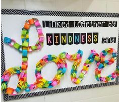 a bulletin board with the words love spelled out in different colors and letters on it