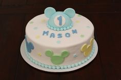 a first birthday cake with mickey mouse on top