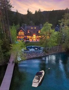 a boat floating on top of a lake next to a house