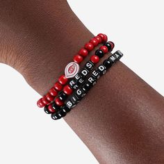 A whole new way to rep the team in style is here. Step up your fan fashion sense with this Cincinnati Reds 3 Pack Beaded Friendship Bracelet. These matching friendship bracelets have an all-over team-colored design and team logo displays, which makes them the perfect way to show your support for the Cincinnati Reds on gamedays and every day in between. Every bead bracelet design is the perfect addition to your outfit, whether you’re heading to the game, watching at home, or just hanging out with Casual Red Beaded Friendship Bracelets, Personalized Red Friendship Bracelets, Casual Red Friendship Bracelets With Letter Beads, Personalized Red Bracelets For Team Spirit, Red Team Spirit Bracelets For Sports Events, Casual Adjustable Wristband For Fan Merchandise, Personalized Red Casual Wristband, Red Black And White Friendship Bracelet, Adjustable Red Bracelets For Sports Events