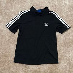 Never Worn Casual Black T-shirt With Three Stripes, Basic Adidas Tops With Three Stripes, Basic Short Sleeve Tops With Three Stripes, Basic Adidas Tops For Streetwear, Classic Adidas Short Sleeve Tops, Black Tops With Adidas Branding For Streetwear, Black T-shirt With Three Stripes, Black Tops With Three Stripes Branding For Streetwear, Black Tops With Three Stripes For Streetwear