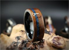 a wooden ring with blue and white inlays