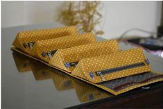 three yellow polka dot bags sitting on top of a table