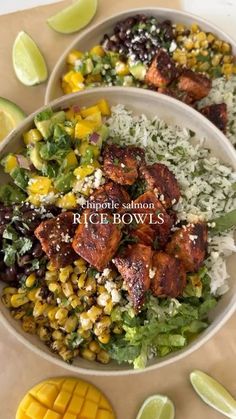 two bowls filled with rice and vegetables next to lime wedges on a table top