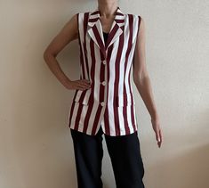 "Choice by Steilmann Vintage Blouse White Red Striped Vest Sleeveless Women Summer Shirt  Shown on model S Measurements (lying flat): Length: 28\"/ 71 cm Shoulder: 15\"/ 38 cm Pit to pit: 19\"/ 48 cm Waist: 16 3/4\"/ 42.5 cm Condition: Good Vintage Condition N.B. Color may slightly differ from picture Please check measurements to insure a proper fit. Remember to allow yourself some extra room for movement. You can compare these with something from your closet that fits you well. Please convo me if you need additional measurements. SHIPPING * I ship worldwide via Priority mail  * Items are shipped 1- 3 business days after receiving the payment. * I ship from Europe, so please allow 2 to 4 weeks for the package to arrive if you live overseas. * Europe 5 - 10 business days. 939 PRO" Retro Red Sleeveless Tank Top, Vintage Summer Vest For Workwear, Retro Red Sleeveless Vest, Red Sleeveless Retro Vest, Vintage Red Vest For Summer, Red Vintage Vest For Summer, Red Vintage Summer Vest, Retro Sleeveless Vest For Work, White Denim Vest