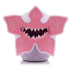 a pink toothbrush holder with teeth on it's face and mouth, in the shape of a monster