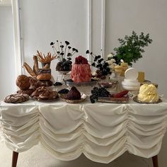 a table topped with lots of different types of cakes and pastries on top of it