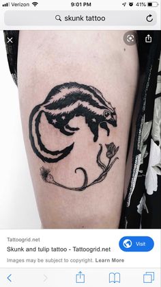 a small black and white animal tattoo on the right thigh