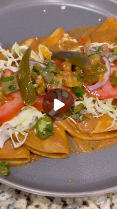 a plate filled with tortilla shells covered in cheese and veggie toppings