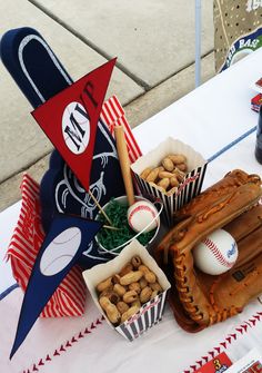 a table topped with baseballs and snacks