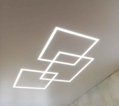 the ceiling is made up of square and rectangle shapes, with white lighting above it