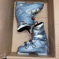 two pairs of ski boots in a box