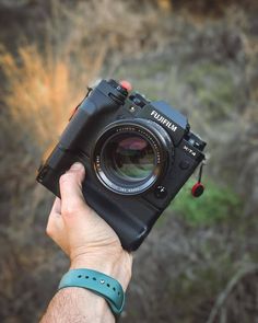 a person holding up a camera in their hand