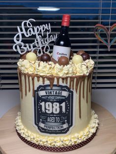 a birthday cake with a bottle of wine in the middle and chocolate decorations on top