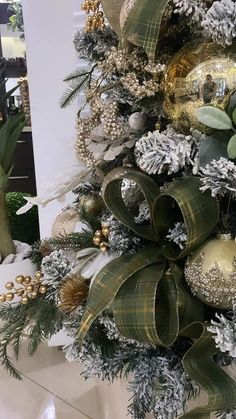 a christmas tree decorated with gold and silver ornaments