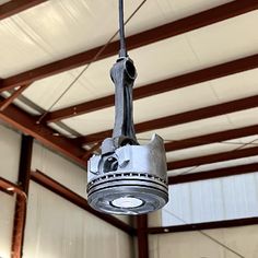 an industrial light hanging from the ceiling in a building