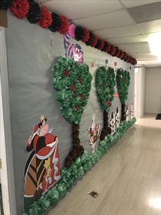 an office hallway decorated with paper mache trees and other decorations on the side wall