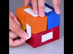 someone is playing with some sort of building block set in the shape of a cube