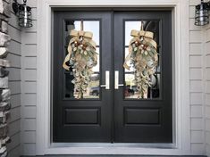 the front door is decorated with wreaths and bows