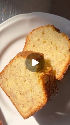 two slices of bread on a white plate with a green olive in the middle, and a video showing how to make it