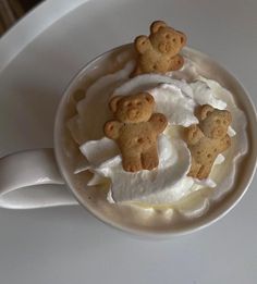 a cup filled with whipped cream and teddy bears