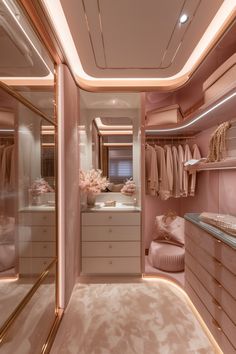 a walk in closet filled with lots of pink furniture and clothes on hangers next to a bed