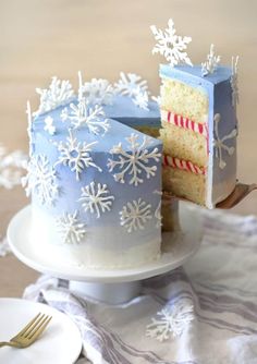 a frosted cake on a plate with a slice cut out