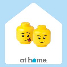 two yellow legos with faces drawn on them and the words at home written below