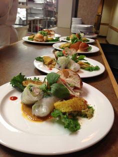 several white plates filled with food on top of a table